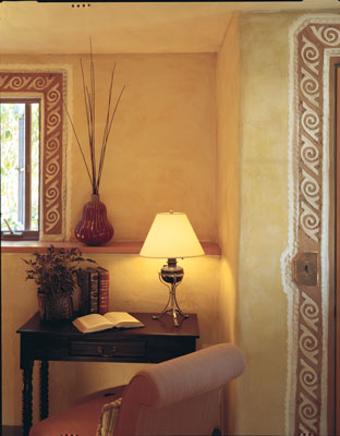 A smaller downstairs bedroom (made possible by the two-story addition and the redesign of the staircase) is rich with earth plasters and decorative detailing.